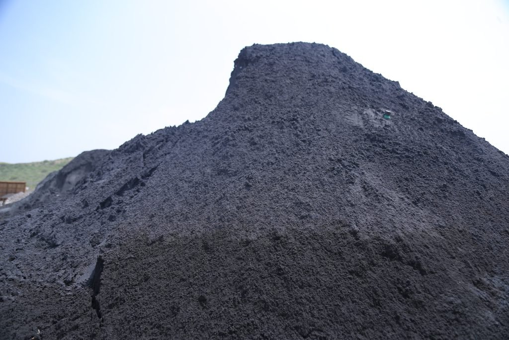 A large mound of black chromite foundry sand used in industrial applications