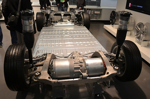 Chassis of an electric vehicle showcasing battery placement and components.