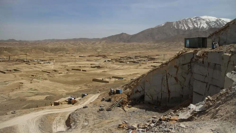 A mining site in Afghanistan with a mountainous landscape in the background, highlighting the country's potential for mineral extraction.