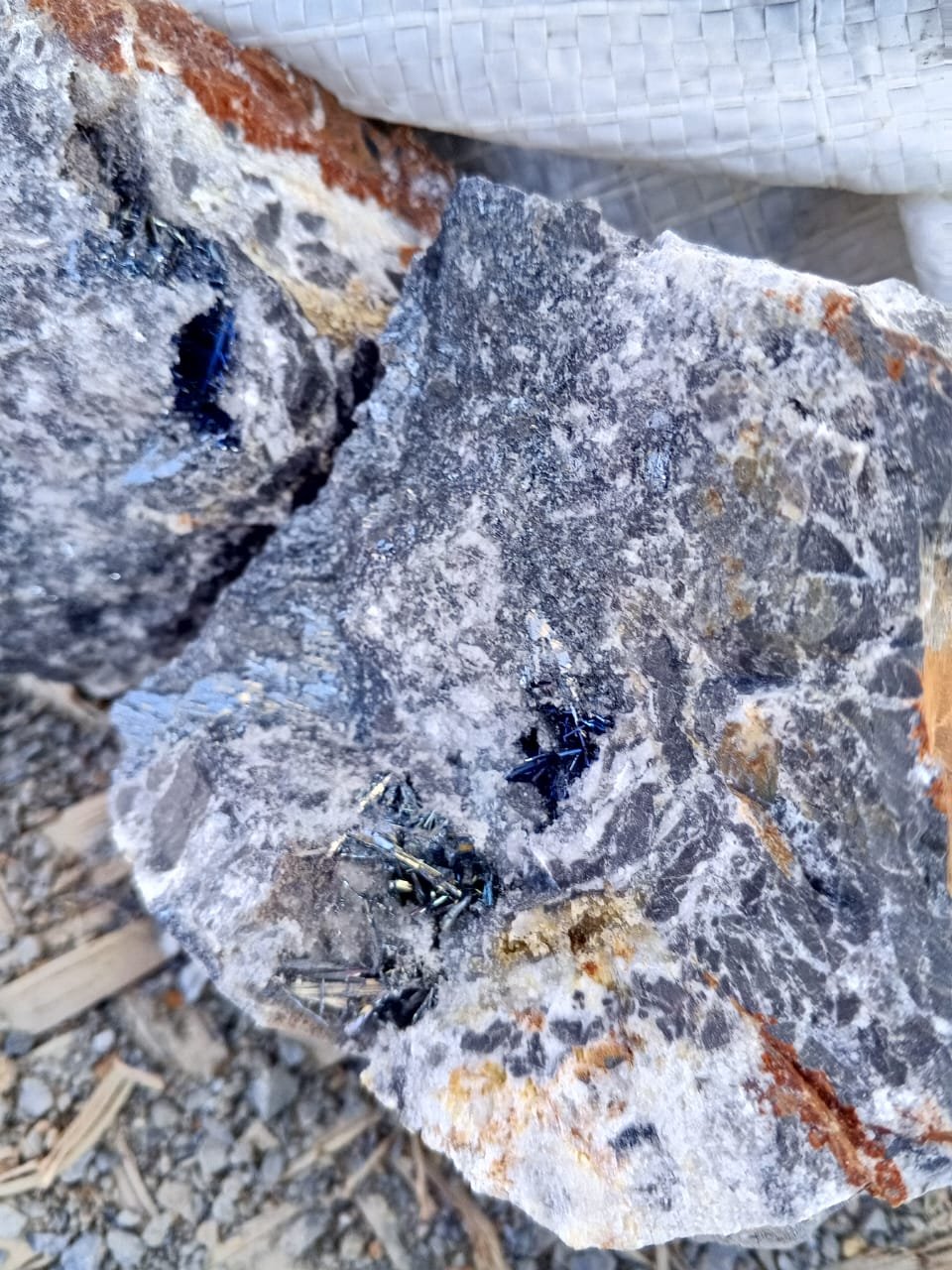 Rough antimony ore with visible metallic crystalline structures sourced by Bare Syndicate, showcasing the mineral's natural form and quality.